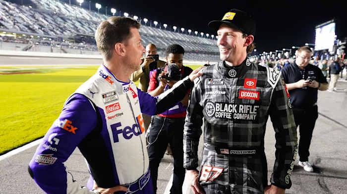 Denny Hamlin (11) congratulates NASCAR Cup Series driver Travis Pastrana (67) after Daytona 500 qualifying.